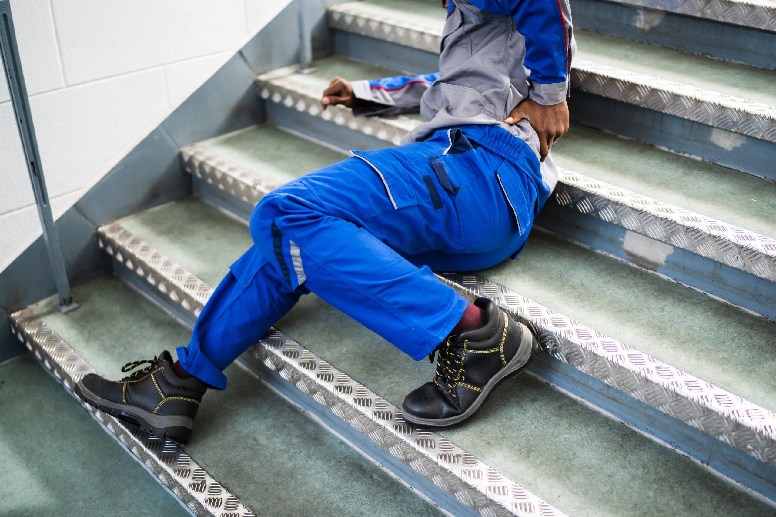 worker fallen down on stairs with back injury